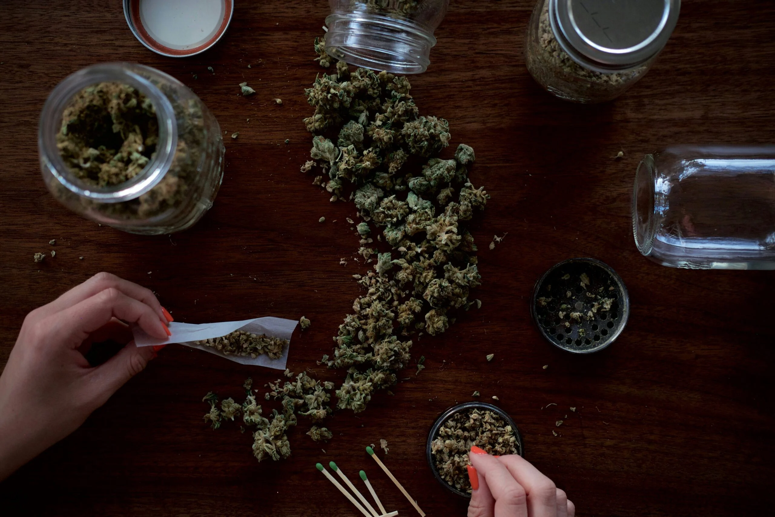 cannabis on a table being rolled into a joint