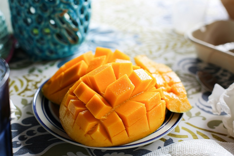 Cut up mango on a table.